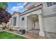 Charming entrance of a stucco home with terracotta roof, featuring a covered porch with decorative columns at 2124 Rising Mist St, Las Vegas, NV 89134