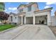 Charming two-story home boasts a well-manicured lawn and open two-car garage at 2124 Rising Mist St, Las Vegas, NV 89134