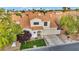 Charming two-story home with a beautiful clay tile roof, well-manicured lawn, and a two-car garage at 2124 Rising Mist St, Las Vegas, NV 89134