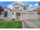 Charming stucco home with terracotta roof, well-kept lawn, and two-car garage in a sunny suburban neighborhood at 2124 Rising Mist St, Las Vegas, NV 89134