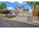 Two-story stucco house boasts a terracotta tile roof, lush lawn, and a convenient two-car garage at 2124 Rising Mist St, Las Vegas, NV 89134