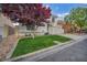 Landscaped front yard leads to a charming two-story home with stucco exterior and terracotta tile roof at 2124 Rising Mist St, Las Vegas, NV 89134