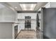 Updated kitchen features stainless steel appliances, white cabinets, and hardwood flooring at 2124 Rising Mist St, Las Vegas, NV 89134