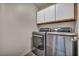 Well-organized laundry room showcasing a side-by-side washer and dryer, plus ample cabinet space at 2124 Rising Mist St, Las Vegas, NV 89134