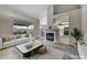 Staged living room with fireplace, modern decor, and an open layout leading to the bright, updated kitchen at 2124 Rising Mist St, Las Vegas, NV 89134