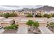 Aerial view of the property showcasing the desert landscaping, garage, and mountains in the background at 2231 Hallston St, Las Vegas, NV 89134