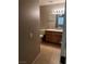 Bathroom with walk-in vanity with granite countertops and light wood cabinetry at 2231 Hallston St, Las Vegas, NV 89134