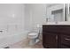 Well-lit bathroom features a shower-tub combination and dark vanity cabinet at 2231 Hallston St, Las Vegas, NV 89134