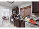 Kitchen with granite countertops, stainless steel appliances, and dark wood cabinets at 2231 Hallston St, Las Vegas, NV 89134