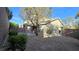 A fully fenced backyard provides privacy with a low maintenance xeriscape landscape and covered patio at 2737 Rimbaud St, Henderson, NV 89044