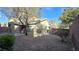 A fully fenced backyard provides privacy with a low maintenance xeriscape landscape and covered patio at 2737 Rimbaud St, Henderson, NV 89044