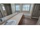 Bright bathroom featuring double sinks, soaking tub, and a glass enclosed shower at 2737 Rimbaud St, Henderson, NV 89044