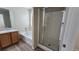 This bathroom features a tile floor, a bathtub and shower, and a glass-enclosed shower at 2737 Rimbaud St, Henderson, NV 89044