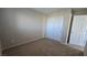 Carpeted bedroom features a closet with white doors and neutral colored walls at 2737 Rimbaud St, Henderson, NV 89044