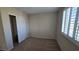 This bedroom has neutral walls, carpet, a closet with sliding doors and shutter blinds at 2737 Rimbaud St, Henderson, NV 89044