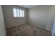 Carpeted bedroom features a window with white shutters and neutral colored walls at 2737 Rimbaud St, Henderson, NV 89044