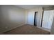Carpeted bedroom features a closet with white doors and neutral colored walls at 2737 Rimbaud St, Henderson, NV 89044