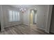 Cozy dining area with wood-look floors, a chandelier, and access to the hallway at 2737 Rimbaud St, Henderson, NV 89044