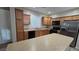 Functional kitchen with stainless steel appliances, wood cabinets, an island, and a double sink at 2737 Rimbaud St, Henderson, NV 89044