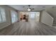 Open-concept living area with wood floors connects to the kitchen and stairway at 2737 Rimbaud St, Henderson, NV 89044