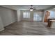 Spacious living room boasts wood-look flooring, modern ceiling fan, and access to kitchen and dining area at 2737 Rimbaud St, Henderson, NV 89044