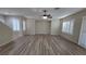 Open-concept living area showcasing wood-look flooring, plantation shutters, and a contemporary ceiling fan at 2737 Rimbaud St, Henderson, NV 89044