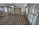 Spacious living room with wood floors, modern ceiling fan, and bright, shuttered windows at 2737 Rimbaud St, Henderson, NV 89044