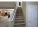 Staircase leads to the upper level near the kitchen with stainless steel appliances at 2737 Rimbaud St, Henderson, NV 89044
