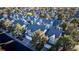 Aerial view of a community of two-story townhomes with blue exteriors and mature trees at 3217 Symphony Dr, Las Vegas, NV 89146