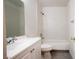Bright bathroom features a shower-over-tub with white-tiled walls and modern fixtures at 3217 Symphony Dr, Las Vegas, NV 89146
