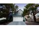 Charming two-story home with a white garage door and light blue exterior with mature landscaping at 3217 Symphony Dr, Las Vegas, NV 89146