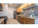 Kitchen featuring wood cabinets, stone countertops, stainless steel appliances, and mosaic backsplash at 3217 Symphony Dr, Las Vegas, NV 89146