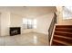 Spacious living room featuring a fireplace, a staircase, and tile flooring at 3217 Symphony Dr, Las Vegas, NV 89146