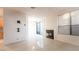 Spacious living room featuring tile floors, a fireplace and sliding door to the patio at 3217 Symphony Dr, Las Vegas, NV 89146