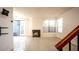 Bright living room featuring a fireplace, sliding glass doors to patio and staircase at 3217 Symphony Dr, Las Vegas, NV 89146