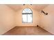 A main bedroom featuring vaulted ceilings, large windows, and neutral carpet at 3217 Symphony Dr, Las Vegas, NV 89146