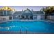 Large outdoor swimming pool with bright blue water, lounge chairs, and a nearby clubhouse at 3217 Symphony Dr, Las Vegas, NV 89146