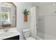 Bathroom with a bathtub and shower, a vanity with a mirror, toilet, and a basket of plants, all contributing to a fresh space at 3218 Mura Del Prato Ave, Henderson, NV 89044
