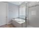 Luxurious bathroom featuring a separate tub and shower, tile surround, and ample natural light creating a spa-like atmosphere at 3218 Mura Del Prato Ave, Henderson, NV 89044