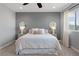 Serene bedroom featuring a queen-size bed, soft neutral colors, plush carpet, and ample natural light from the window at 3218 Mura Del Prato Ave, Henderson, NV 89044