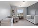 Cozy Bedroom with crib, chair, changing table, and bright natural light at 3218 Mura Del Prato Ave, Henderson, NV 89044