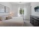 Comfortable bedroom featuring a queen-size bed with white bedding, dresser, neutral walls and a window with natural lighting at 3218 Mura Del Prato Ave, Henderson, NV 89044