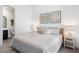 Bright bedroom featuring neutral tones, decorative wall art, and ample natural light from the doorway to an ensuite at 3218 Mura Del Prato Ave, Henderson, NV 89044