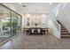 Bright dining room featuring tile flooring, modern lighting and a large sliding door to a patio at 3218 Mura Del Prato Ave, Henderson, NV 89044