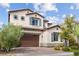 Charming two-story home with a two-car garage and well-maintained landscaping, enhanced by a beautiful blue sky at 3218 Mura Del Prato Ave, Henderson, NV 89044