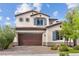 Charming two-story home with a brown garage door, blue shutters, and manicured landscaping at 3218 Mura Del Prato Ave, Henderson, NV 89044