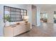 Inviting foyer features tile flooring and a modern console table, leading to a bright and airy living space at 3218 Mura Del Prato Ave, Henderson, NV 89044