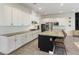 Open kitchen featuring white cabinets, granite countertops, stainless steel appliances, and a large island at 3218 Mura Del Prato Ave, Henderson, NV 89044