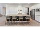 Modern kitchen featuring a large island with bar seating, stainless steel appliances, and white cabinetry at 3218 Mura Del Prato Ave, Henderson, NV 89044