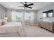 Spacious main bedroom with plush carpet, ceiling fan, and a dresser with a television at 3218 Mura Del Prato Ave, Henderson, NV 89044